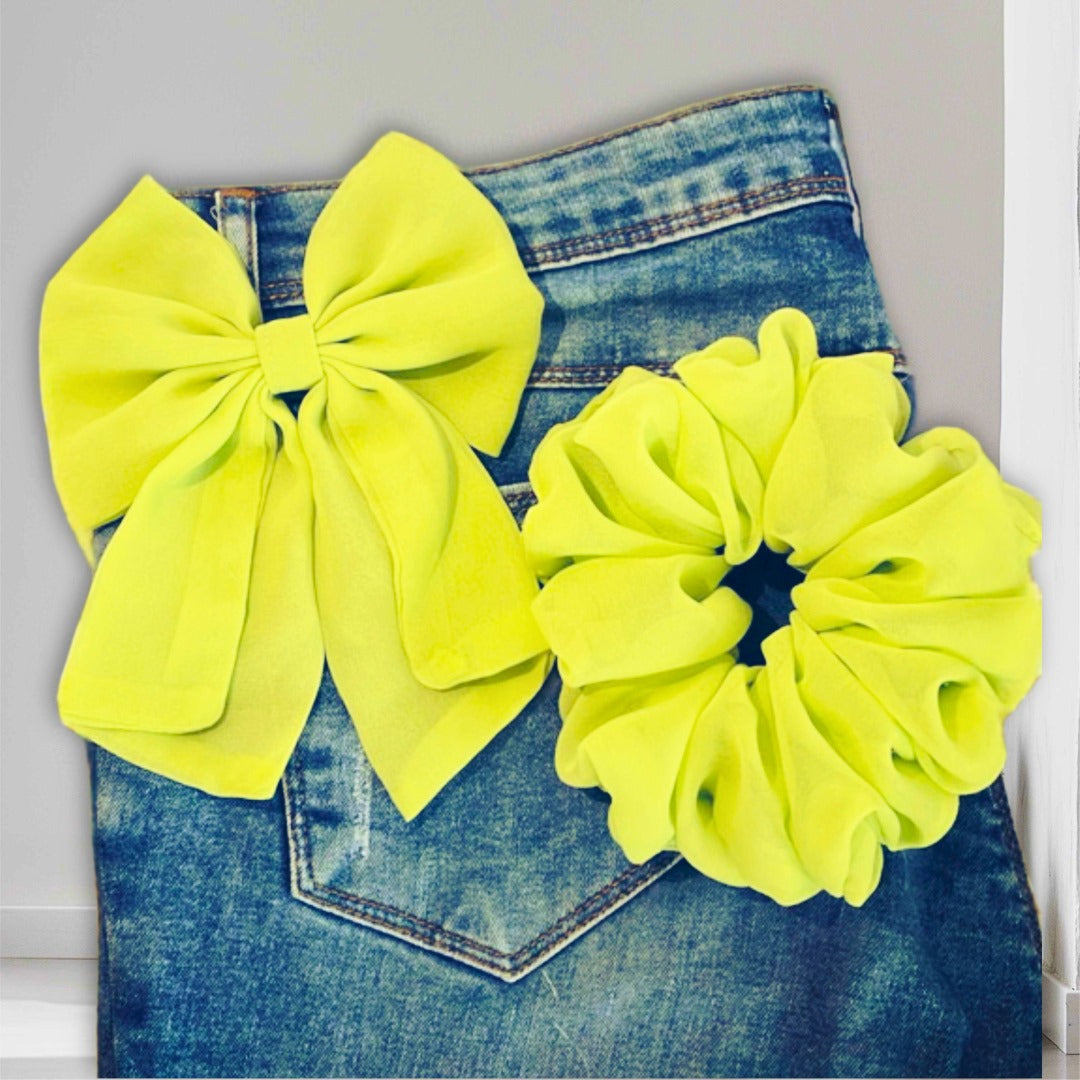 Elegant satin scrunchie with matching bow, perfect for sleek, polished hairstyles.