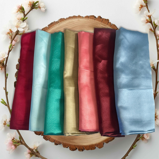 Soft satin hair pillow by PixiePins on a bed, designed to prevent frizz and hair breakage while sleeping.
