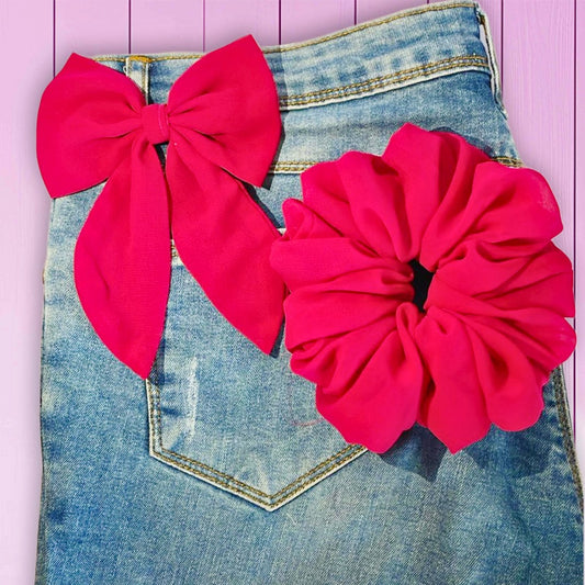 Vibrant hot pink scrunchie with bow, perfect for bold and playful hairstyles.